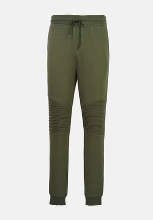 Joggingbroek in olijfgroen met geribbelde kniepanelen, een elastische tailleband met trekkoord, zijzakken en geribbelde enkelboorden.