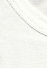 White cotton fabric with a smooth texture. Features a rounded neckline with a ribbed trim, showcasing a minimalist design.
