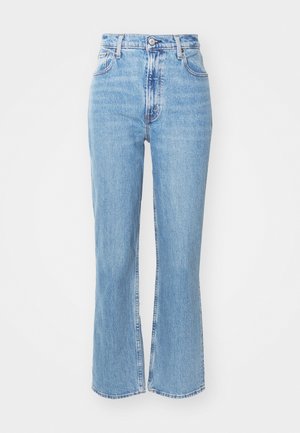 Light blue high-waisted jeans with a flared leg. Made of denim, featuring five pockets and a button front closure. Faded texture.