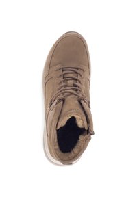 Stivale alla caviglia in suede marrone con punta arrotondata, lacci frontali e morbida foderatura in pelliccia. Presenta una suola in gomma spessa e un design minimalista.
