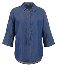 Camicia di jeans di colore blu scuro, presenta un collo a camicia, chiusura frontale con bottoni e maniche a tre quarti con polsini. Orlo inferiore arrotondato.