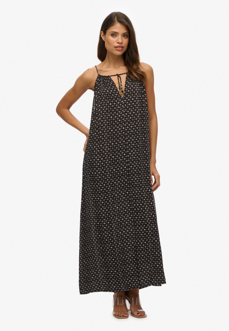 Zwarte maxi-jurk met bloemenprint, spaghettibandjes en een V-hals. Lichtgewicht stof valt losjes tot op enkel lengte.