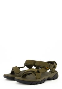 Sandalias verde olivo con correas ajustables, plantilla acolchada y suela exterior de goma negra. Presenta una superficie texturizada para mayor agarre.