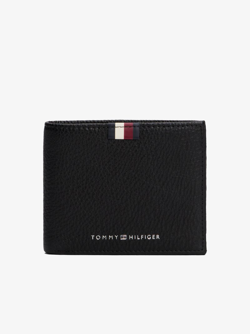 Black leather wallet with textured surface, featuring a small red, white, and blue flag detail at the top and silver brand logo at the bottom.