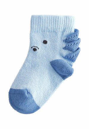 Calzino in cotone azzurro chiaro con punta blu scuro, dettagli a ondina e due occhi neri ricamati sul lato.