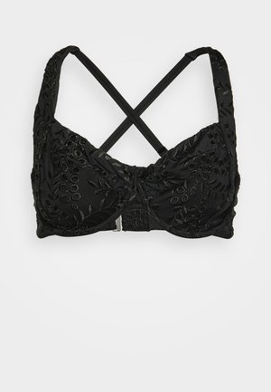 Sutiã preto com bordado floral texturizado, alças cruzadas ajustáveis e fecho de mola. Tecido suave com uma forma estruturada.