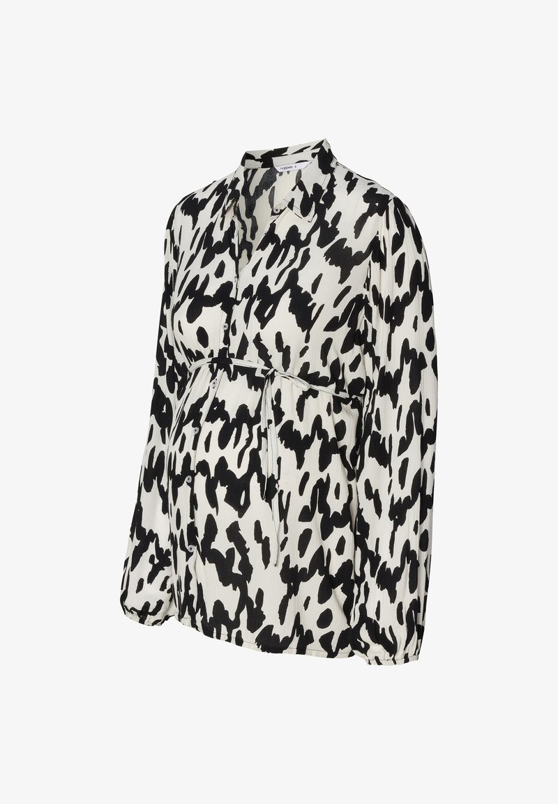 Maternity blouse in a black and white abstract print. Features a buttoned front, collared neckline, and elastic waistband for fit. Long sleeves.