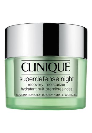 Clinique Superdefense Night moisturizer in a clear green jar with a silver metallic lid, labeled for combination oily skin types.