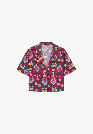 Camicia a maniche corte, con bottoni, caratterizzata da vivaci motivi floreali e astratti in rosa, teal, giallo e bianco, e colletto aperto.