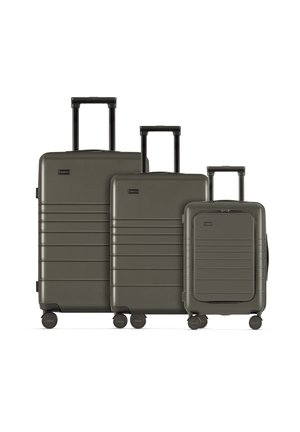 Set of three hard-shell suitcases in olive green. Features textured surfaces, vertical grooves, retractable handles, and spinner wheels.