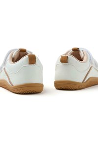 Zapatillas de cuero azul claro con una textura suave, que presentan una suela de goma marrón y un sutil detalle de costura. La vista trasera muestra una lengüeta.