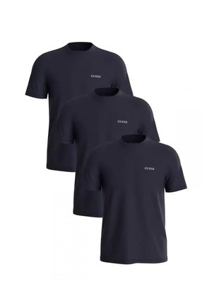 Trois t-shirts noirs à manches courtes et col rond avec un petit logo blanc "GUESS" sur la poitrine gauche, disposés en rangées décalées.