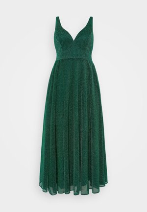 Emerald green sleeveless dress with a deep V-neck, flowy fabric, sparkly texture, and a long, sweeping skirt.
