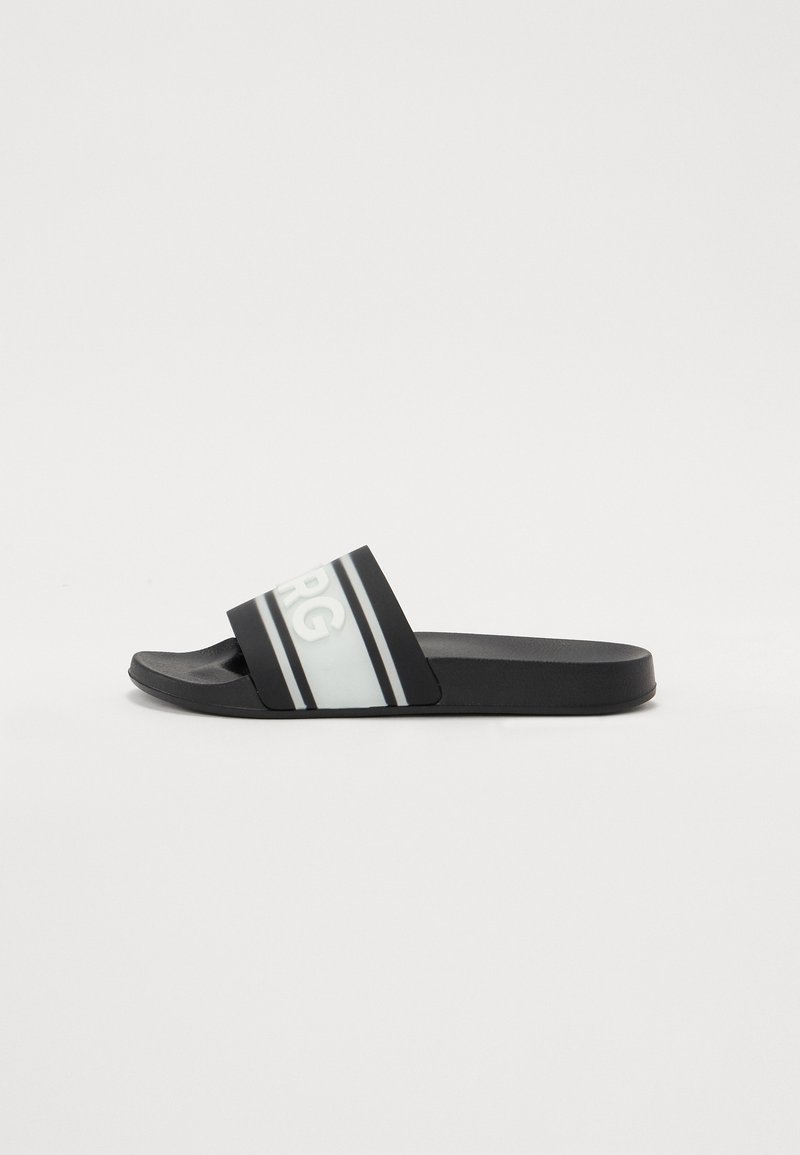 Black slide sandal with a flat sole, featuring a wide strap printed with white logo and double stripes in grey, made of synthetic material.