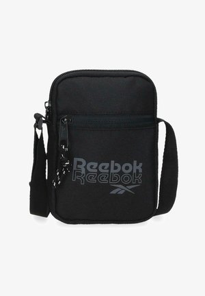 Bolso bandolera compacto negro de Reebok con bolsillo frontal con cremallera, correa ajustable y logo impreso en el panel frontal.