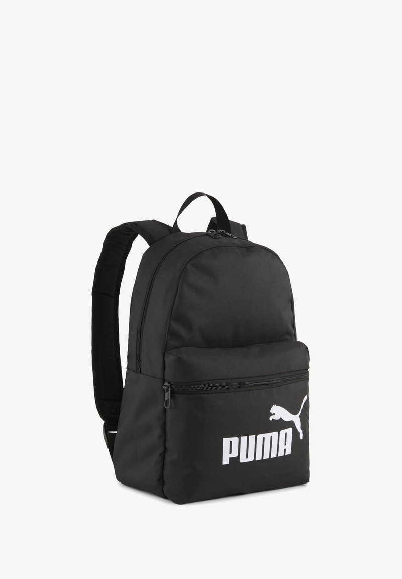 Svart tygryggsäck med vadderade remmar, rundad topp, framficka med dragkedja och stor vit Puma-logga på framsidan. Slät textur, minimal design.