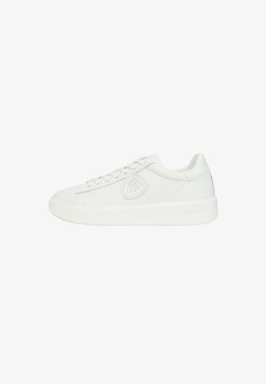 Sneaker bianco in pelle con una texture liscia, punta tondeggiante e suola piatta in gomma. Presenta una patch con logo sul lato e un classico design con lacci.