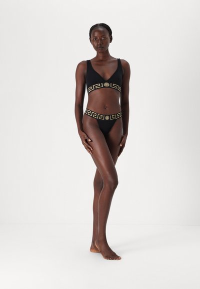 Black two-piece swimsuit with a geometric gold pattern on the band. The top has a V-neck and thick straps, while the bottom features a high-cut design.