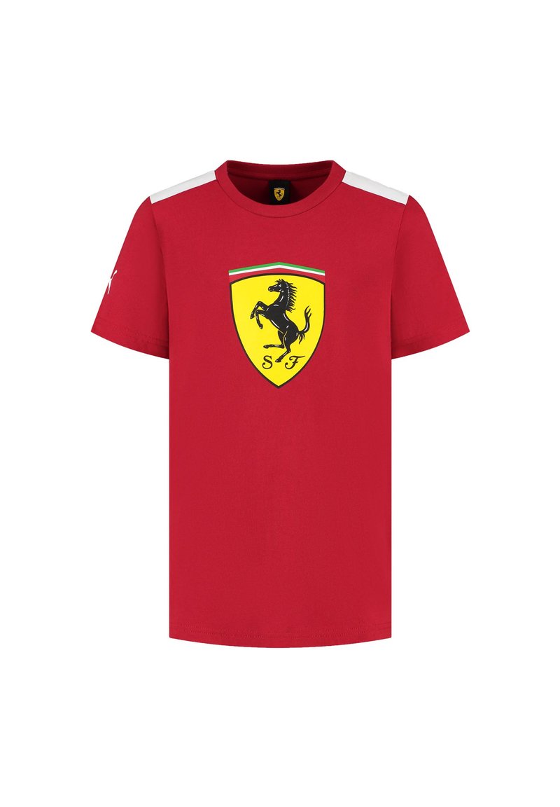 Czerwona bawełniana koszulka z krótkimi rękawami, okrągłym dekoltem i czarnym logiem skaczącego konia w żółtej tarczy z przodu. Białe akcenty na ramionach.