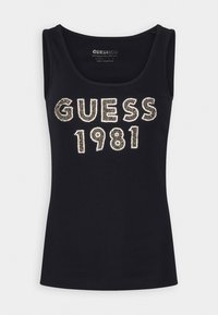Canotta nera senza maniche con testo "GUESS 1981" decorato da strass sul fronte, tessuto a coste e scollo rotondo.