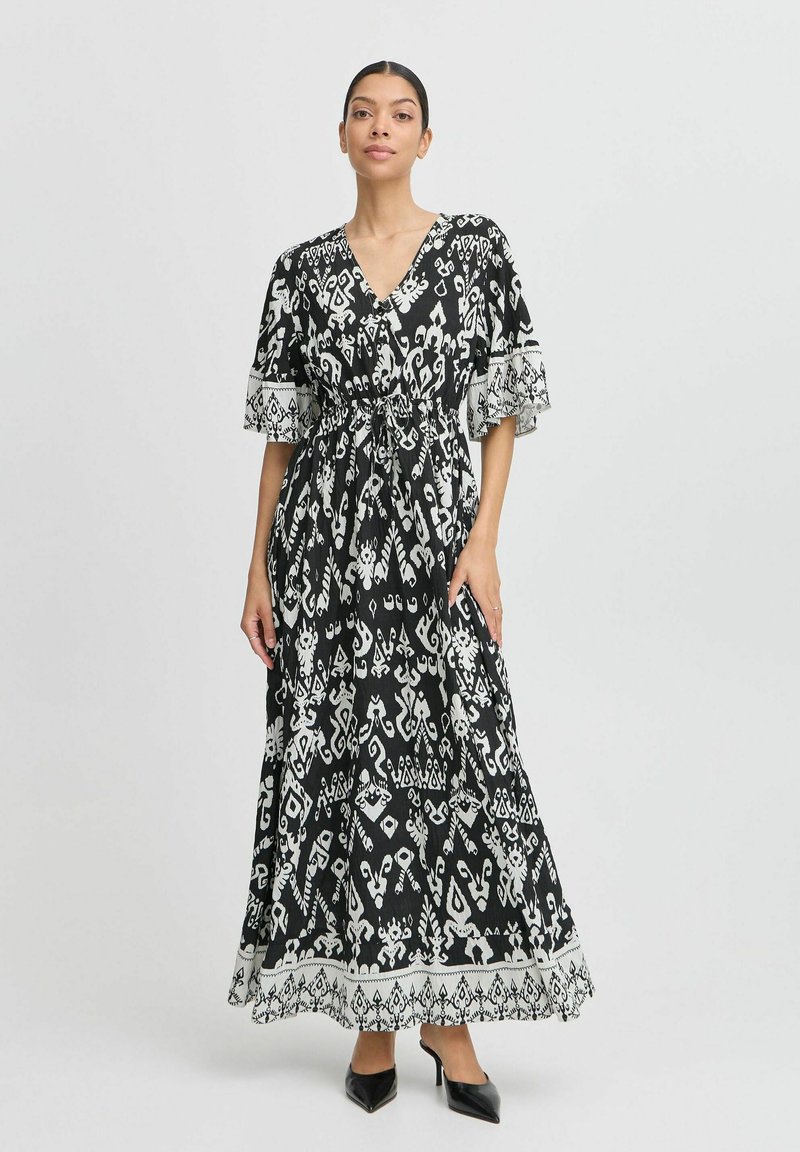 Maxikleid in Schwarz und Weiß mit Wickeldesign, kurzen Ärmeln, Kordelzug in der Taille und komplizierten Mustern am Saum.