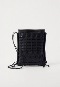 Black woven leather crossbody bag with a smooth top, adjustable strap, and open top design. Features intricate braided texture.