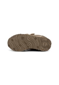 Suola in gomma marrone con una texture ondulata e motivi circolari. Design della trazione notevole con scanalature equidistanti.