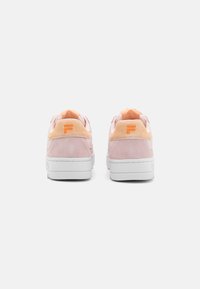 Suedesneakers i lys pink med orange accenter og en hvid gummisål. Har en tekstureret bagside og logo detaljer nær hælen.