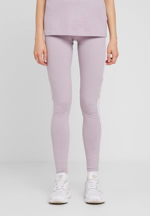 Light purple leggings made of stretchy fabric with a smooth texture, featuring white side stripes and branding near the ankle.