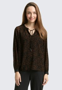 Braunes Leopardenmuster-Blusenshirt mit langen Ärmeln, V-Ausschnitt und Kordelzug. Leichter Stoff mit subtiler Textur und elastischen Bündchen.