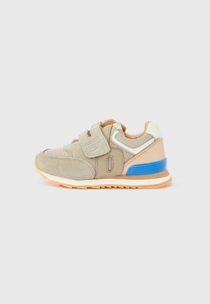 Light gray athletic shoe with velcro strap, beige accents, blue heel detail, and textured fabric upper, set on a rubber sole.