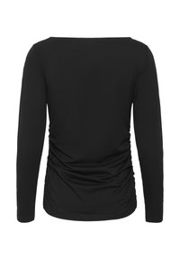 Svart långärmad topp med rundad halsringning och samlad struktur längs sidorna. Tillverkad av mjukt, stretchigt material.