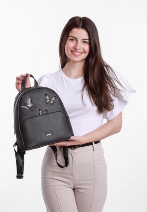 Black leather backpack featuring embroidered butterflies, zip closure, top handle, adjustable straps, and a logo accent.