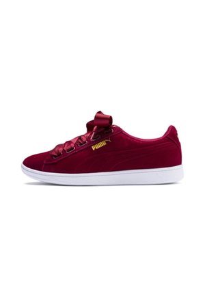Low-top burgundy velvet Puma sneaker with satin ribbon laces, gold logo on side, and white rubber sole, viewed from the outer side.