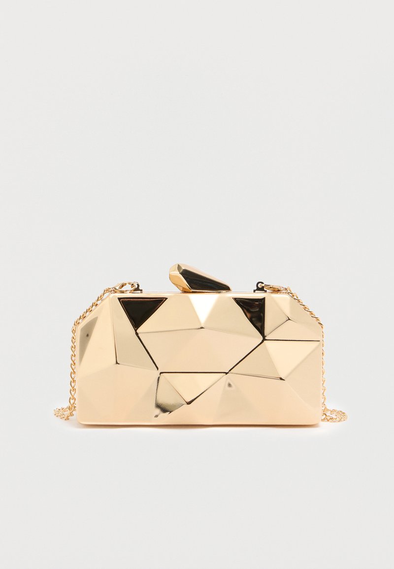 Zelta ķīmiski ģeometriskas formas vakara soma ar spīdīgu metālisku apdari, augšpusē ar melnu akcentu un noņemamu ķēdes siksnu.