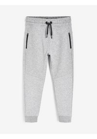 Pantalon de survêtement gris avec taille élastique, cordon de serrage et poches latérales zippées. Texture lisse, design de jambe fuselée et détails de genou renforcés.