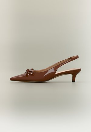 Brown patent leather slingback kitten heel shoe with pointed toe and small bow detail on front side.