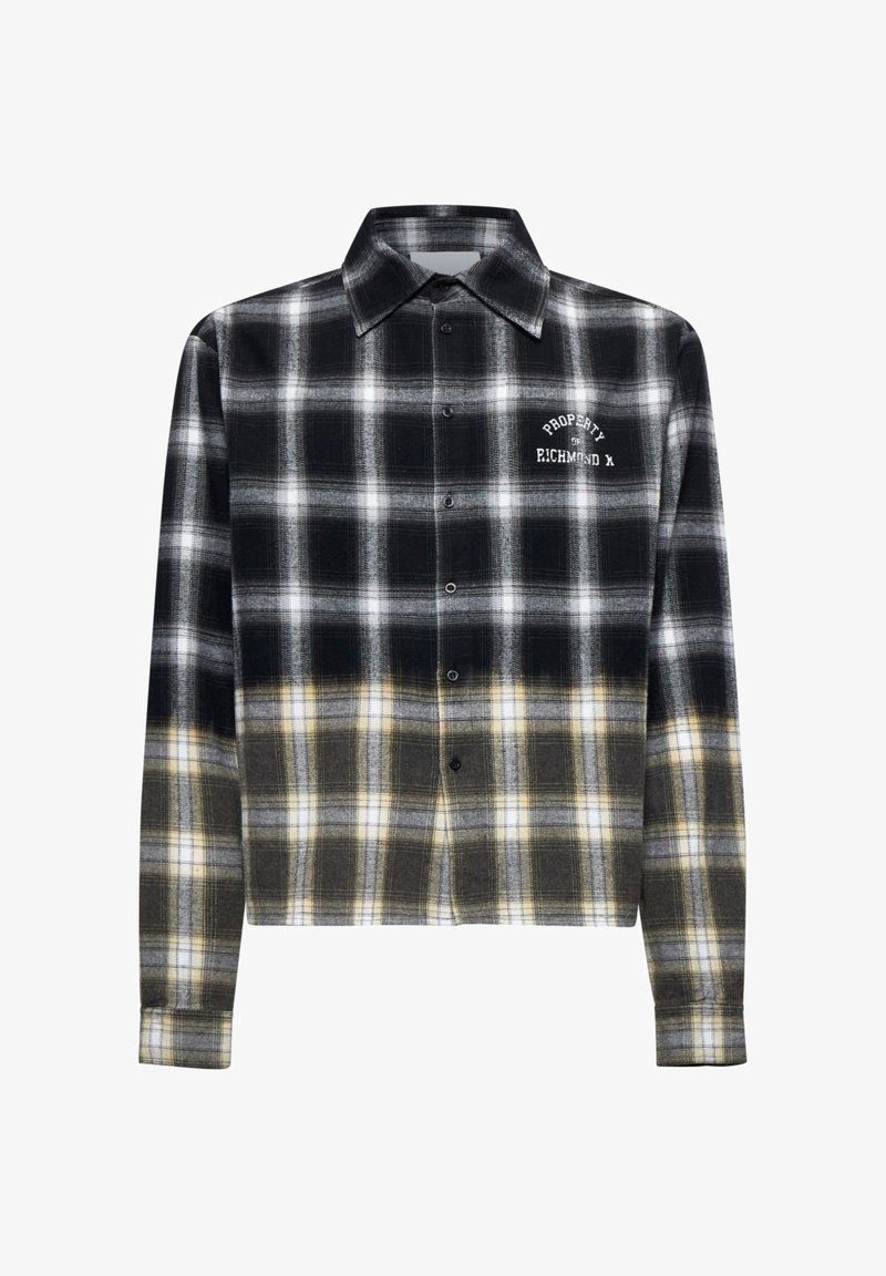 Camicia a scacchi in bianco e nero con accenti gialli, design cropped, chiusura con bottoni frontale e testo ricamato sul petto. Realizzata in materiale flanella.