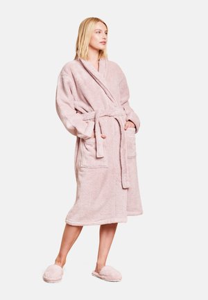 Light pink plush bathrobe with a shawl collar, tie belt, and two front pockets; worn with matching soft slippers.