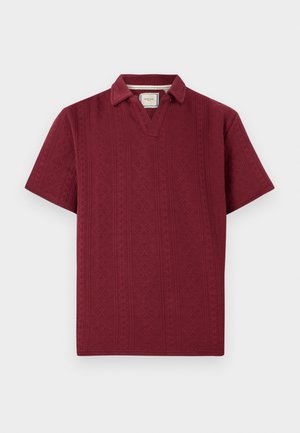 Burgundy short-sleeve polo shirt with a textured pattern, featuring a partial collar and a relaxed fit.