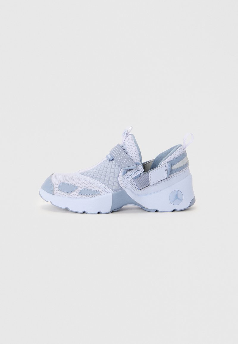 Light blue athletic shoes with mesh and synthetic materials, featuring a textured upper, adjustable strap, and a raised logo on the heel.