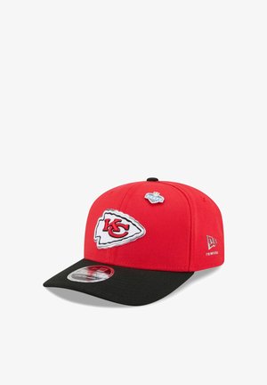 Rot-schwarze Kansas City Chiefs Kappe mit Logo-Aufnäher vorne, NFL Draft Anstecker oben und New Era Logo an der Seite.