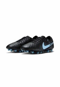 Black soccer cleats made of leather, featuring a textured upper, blue accents, rounded toe, and molded studs for traction.