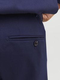 Navy blue suit trousers featuring a sleek fabric, a back pocket with a button closure, and a clean, tailored design.