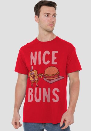 Red cotton t-shirt featuring a cartoon character and the phrase "NICE BUNS" in large white letters, with a humorous burger illustration.