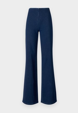 Dunkelblaue, aus Denim gefertigte Schlagjeans mit elastischem Bund. Sie zeichnen sich durch eine glatte Textur und ein weites Beindesign bis zum Saum aus.