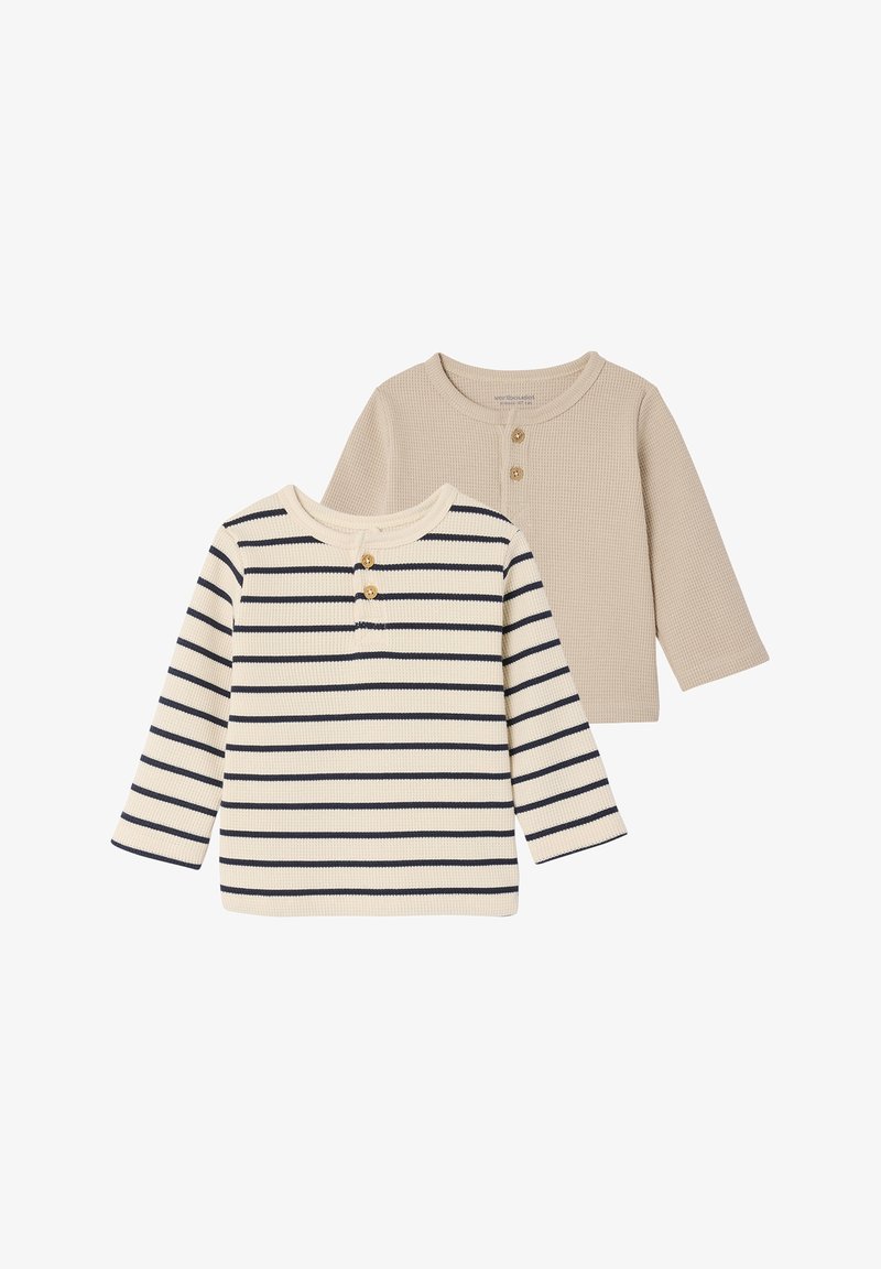 Two long-sleeve shirts: one is beige and the other is cream with navy stripes. Both have a ribbed texture and button detailing at the neck.