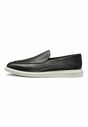 Black leather slip-on shoes with a smooth texture, featuring a rounded toe and a contrasting white rubber sole. Minimal design with no visible hardware.
