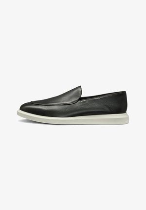 Black leather slip-on shoes with a smooth texture, featuring a rounded toe and a contrasting white rubber sole. Minimal design with no visible hardware.