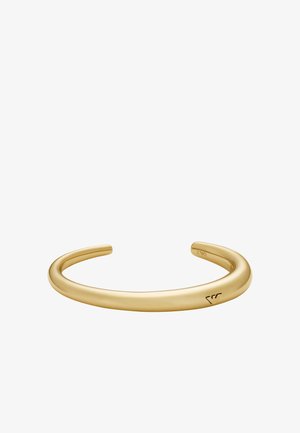 Gold-tone cuff bracelet with a smooth, rounded shape and a polished finish. Features engraved logo detail on one end. No embellishments.